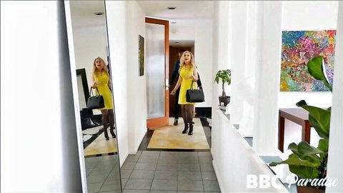 Busty MILF Nina Hartley in tight yellow dress, walking with boss in office