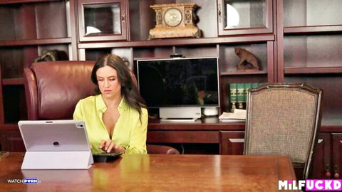 Penny Barber in seductive yellow blouse at office desk, big tits MILF