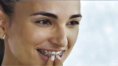 Claudia Bavel smiling with braces, teasing in lesbian pussy licking scene