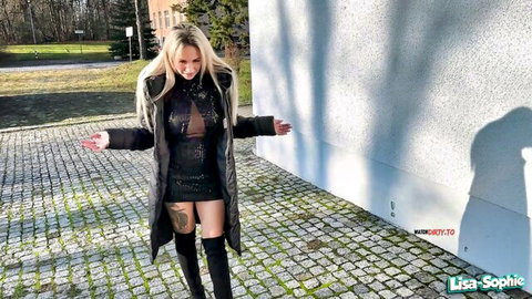 Blonde babe flashing big tits through sheer sparkly dress with open coat and thigh-high boots outdoors