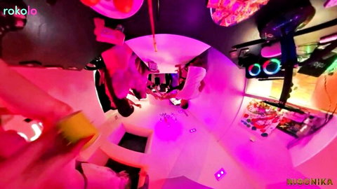 Wild pink neon-lit rave party scene in distorted fisheye club view with sexy crowd