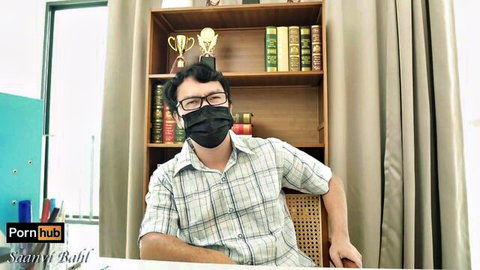 Saanvi Bahl as masked Indian teacher in plaid shirt at desk