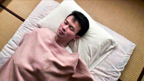 Asian teen male in pink hoodie lying relaxed on futon, first time episode