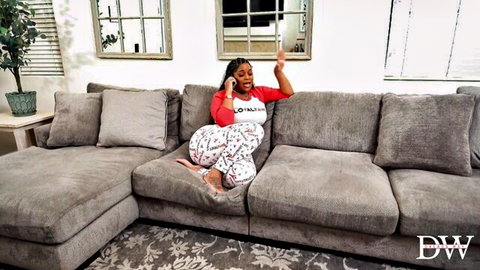 Curvy ebony babe with huge ass and tits in tight pajamas spreading legs on sofa while on phone