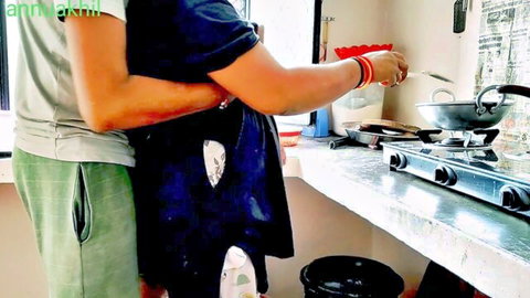 Indian husband hugs curvy housewife from behind in steamy kitchen while she stirs pot