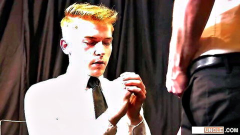 Blonde twink kneels praying submissively before shirtless muscular stud in gay tease