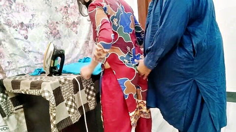 Pakistani housewife in salwar kameez bent over ironing board groped by man from behind in kitchen