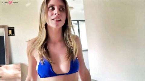 Busty blonde teen in skimpy blue bikini top flaunting massive cleavage POV