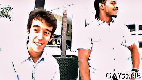 Cute white twink smiling with muscular black bodybuilder in gay scene