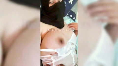 Hijab-wearing Arab babe exposes her big bare tit and nipple in pulled-down white lingerie