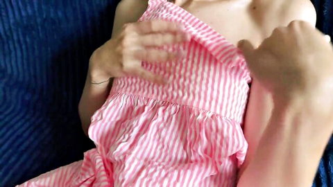 Brunette amateur lifts pink striped dress fingering pussy on couch