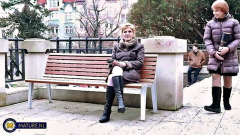 Irenka and Romana in coats and boots seduce young boy on outdoor bench
