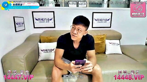 Asian man in glasses sitting on couch holding phone, Peach Media small model delivery teaser