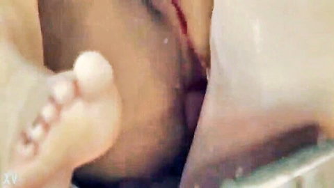 Close-up anal squirting and pussy handjob with bare foot and breast visible