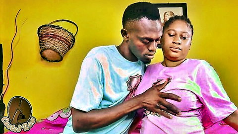 Nigerian pornstar Queen Diva in intimate embrace with man grabbing her breast