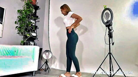 Curvy ebony babe poses sideways in tight green leggings showing off her big juicy ass and hips
