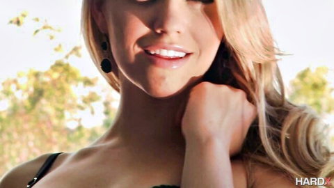 Mia Malkova smiling seductively in black lingerie, blonde hair, outdoor tease