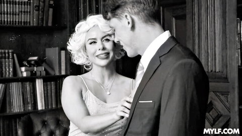 Blonde bombshell in sparkly slip dress grabs suited man's tie seductively in library