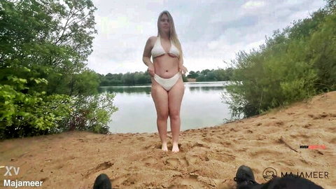 Maja Meer curvy blonde in white bikini posing on beach by lake