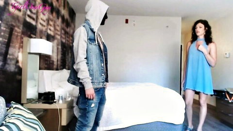 Stepmom in blue dress stands over young hooded man in hotel room preview