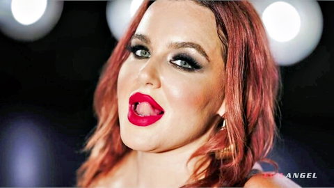 Natasha Nice seductive close-up with red hair, glossy red lips and tongue out
