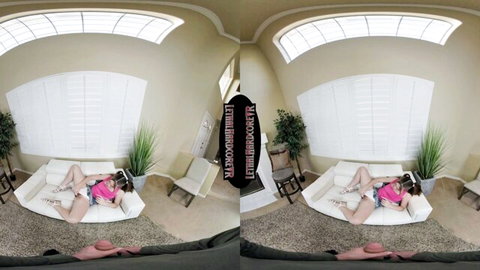 Skinny young brunette with small tits spreads legs wide teasing pussy on couch in VR