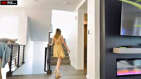 Blonde petite teen in short floral dress walks downstairs teasing her small ass and legs
