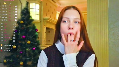 Redhead camgirl teases with fingers in mouth in holiday outfit