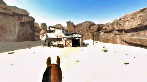 Rugged desert shack viewed from horseback in rocky canyon landscape