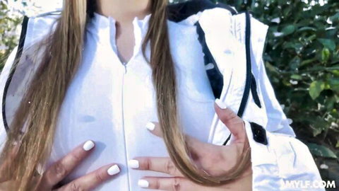 Jessie Rogers teases big tits in open white jacket outdoors