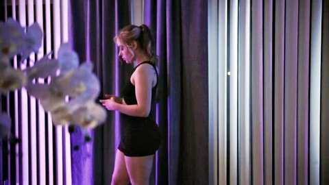 Anna Claire Clouds in tight black top and shorts, blonde ponytail solo pose