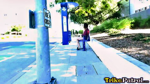 Aubree Ice in red top at bus stop, teasing for public hookup on Trikepatrol
