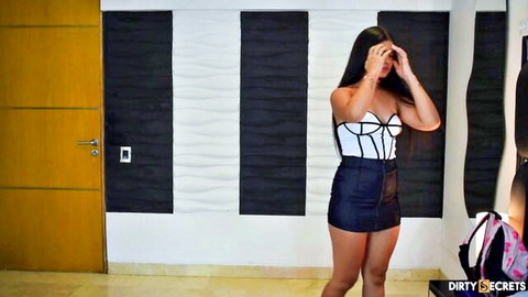 Sexy Malay woman in white corset and black mini skirt, long hair, seductive pose