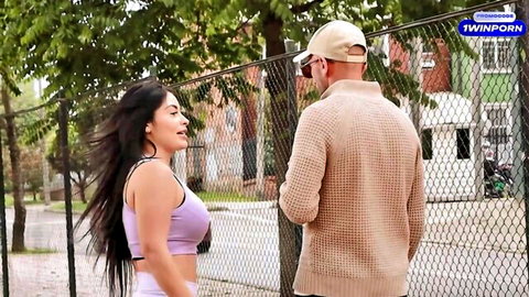 Sexy Latina with big tits in tight purple bra teasing guy outdoors by fence