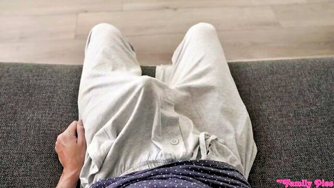 POV closeup of guy's huge cock bulge straining gray sweatpants on couch
