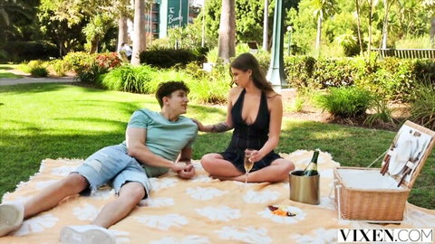 Vixen debutante Skybound in sexy black dress at outdoor picnic with man, teasing vibe