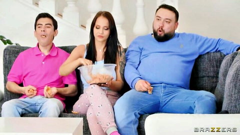 Jennifer Mendez in polka dot pajamas with two men on couch, threesome tease