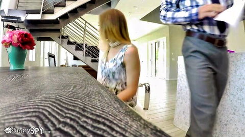Petite blonde leans over kitchen table looking back at boss in plaid shirt ready for sneaky fuck