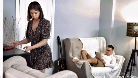 Thea Lun in floral dress teasing stud in cozy living room prep