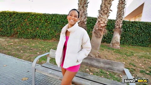 Samantha Cruuz smiling in pink mini dress and white jacket outdoors