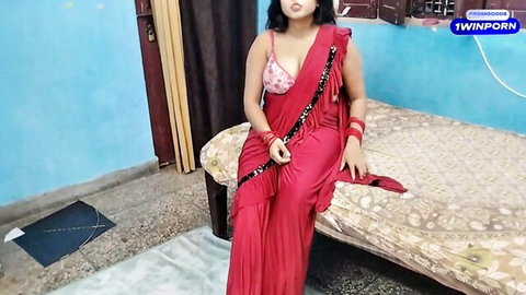 Sexy Indian babe in red saree teasing with deep cleavage on bed
