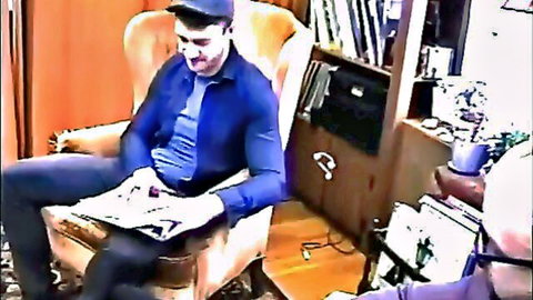 The Professor seated in chair reading newspaper, clothed adult thumbnail