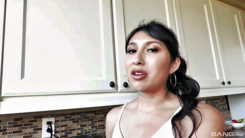 Penelope Woods in white top, teasing in kitchen with open mouth