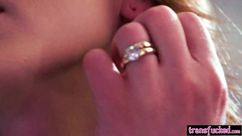 Blonde woman in profile touching earring with ringed hand, seductive close-up from Izzy Wilde's Brazzers scene