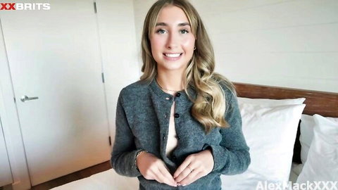 Lily Phillips smiling seductively in open gray cardigan