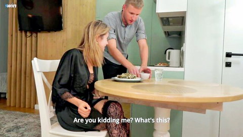 Blonde Leo Dee in silk robe and stockings reacts surprised at dinner with man