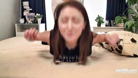 Blurry brunette Asian woman crawls on bed in tight black top showing tits cleavage