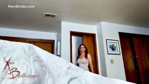 Curvy brunette MILF Xev Bellringer teases with big tits in tight top by bedroom bed