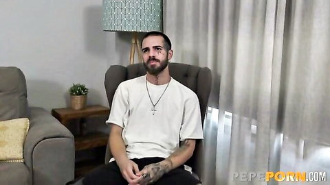 Tattooed bearded guy in white tee on casting couch interview