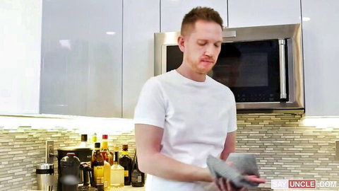 Zacc Andrews in white tee holding cloth in kitchen tease